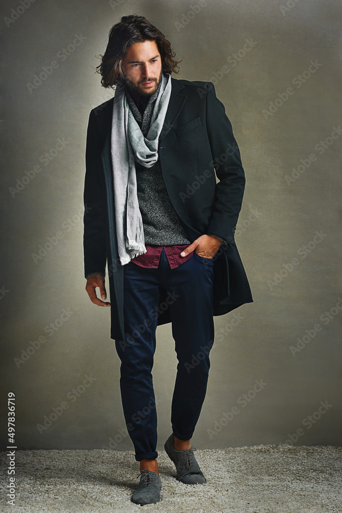 Fashion changes, style endures. Shot of a stylishly dressed man posing against a gray background in 