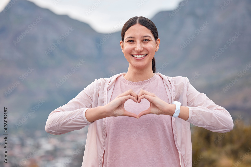 照顾她的心脏健康。一名年轻女子在锻炼时用手做心形的照片