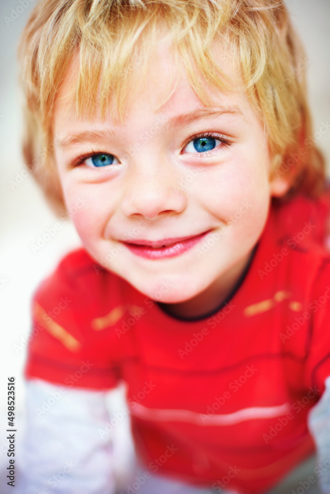 An innocent little boy giving you a cute smile. Closeup portrait of an innocent little boy giving yo