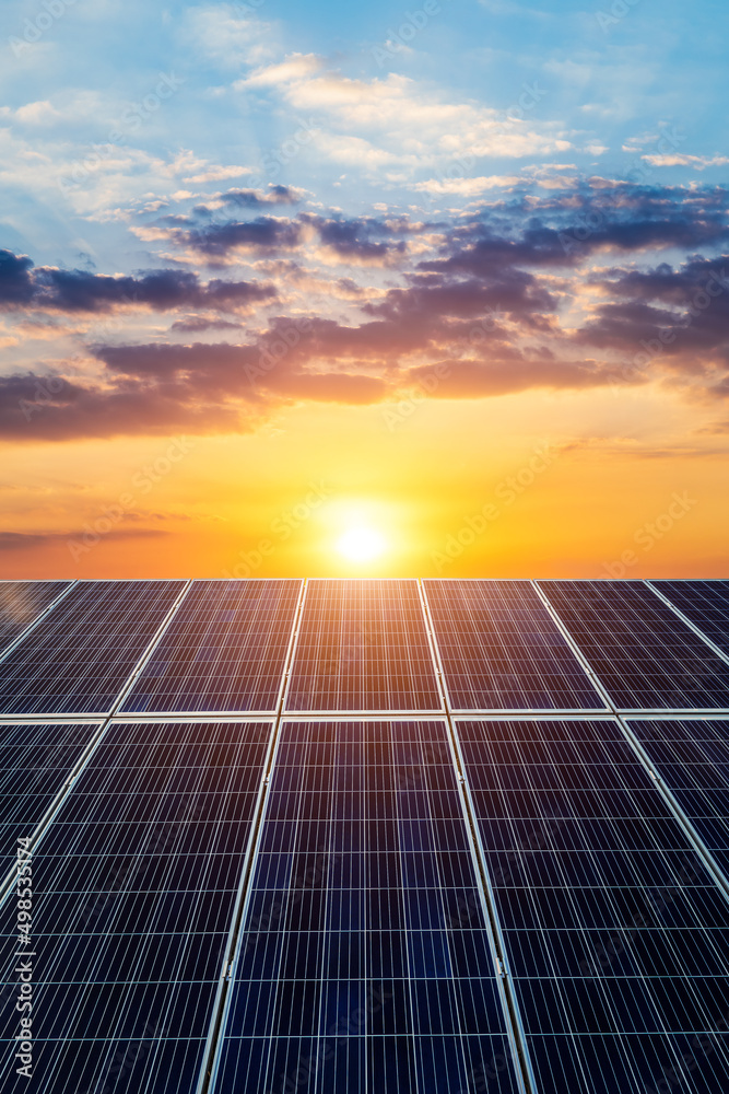 太阳能电池板和美丽的日落云。绿色能源概念。