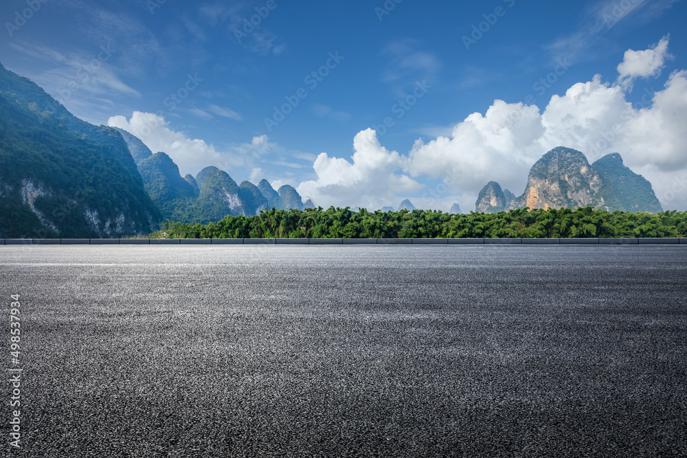 Asphalt highway and mountain natural landscape under blue sky in summer. Road and mountain backgroun