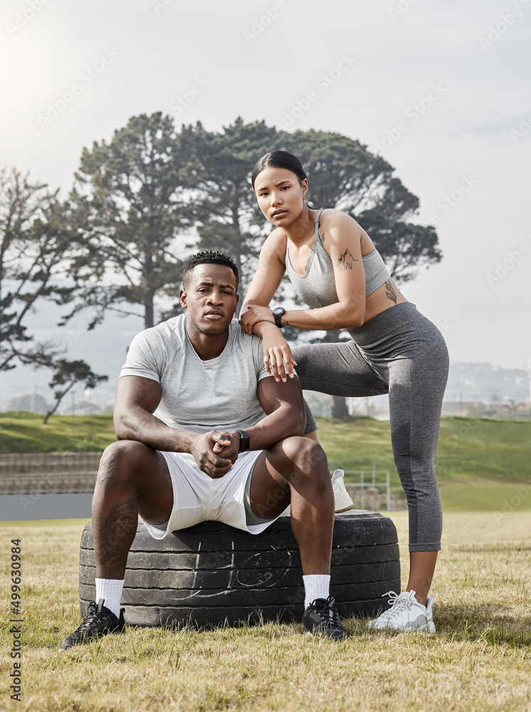 A strong man needs a strong woman by his side. Shot of an athletic man and woman posing together out