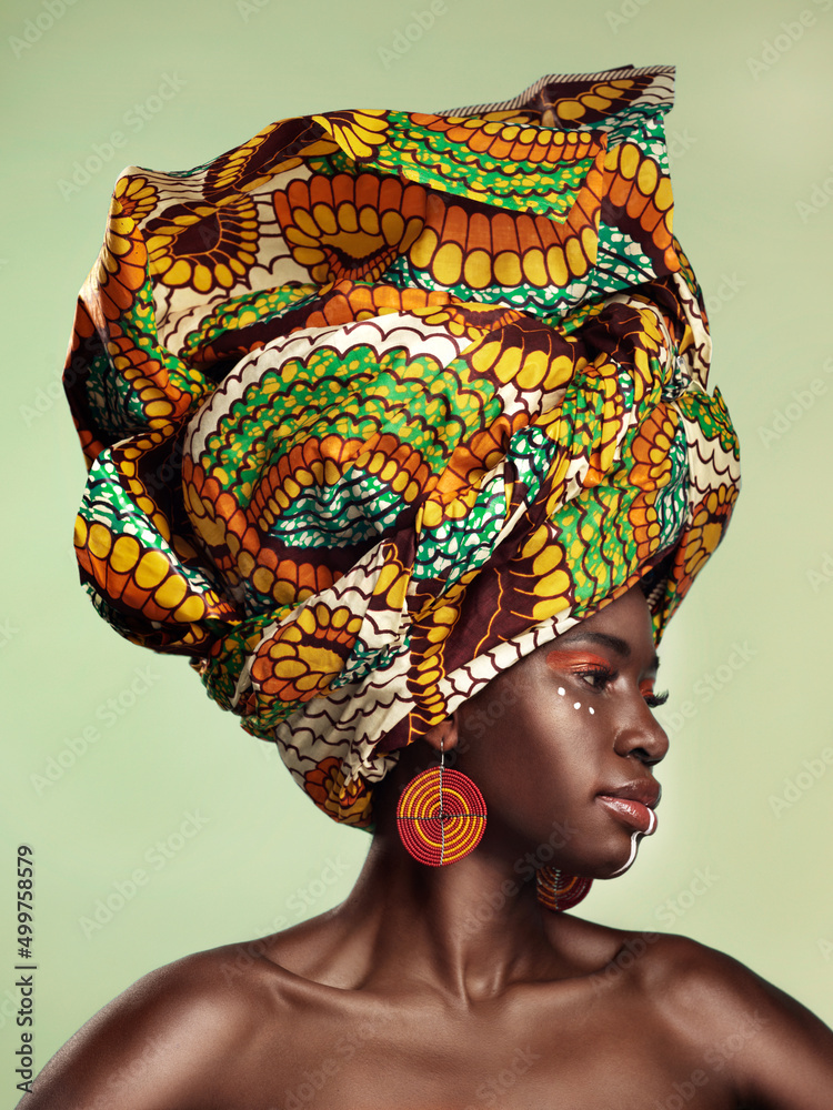 Life is better in colour. Studio shot of a beautiful young woman wearing a traditional African head 
