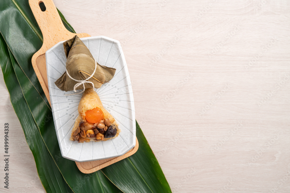 Zongzi. Rice dumpling for Dragon Boat Festival on bright wooden table background with ingredient.