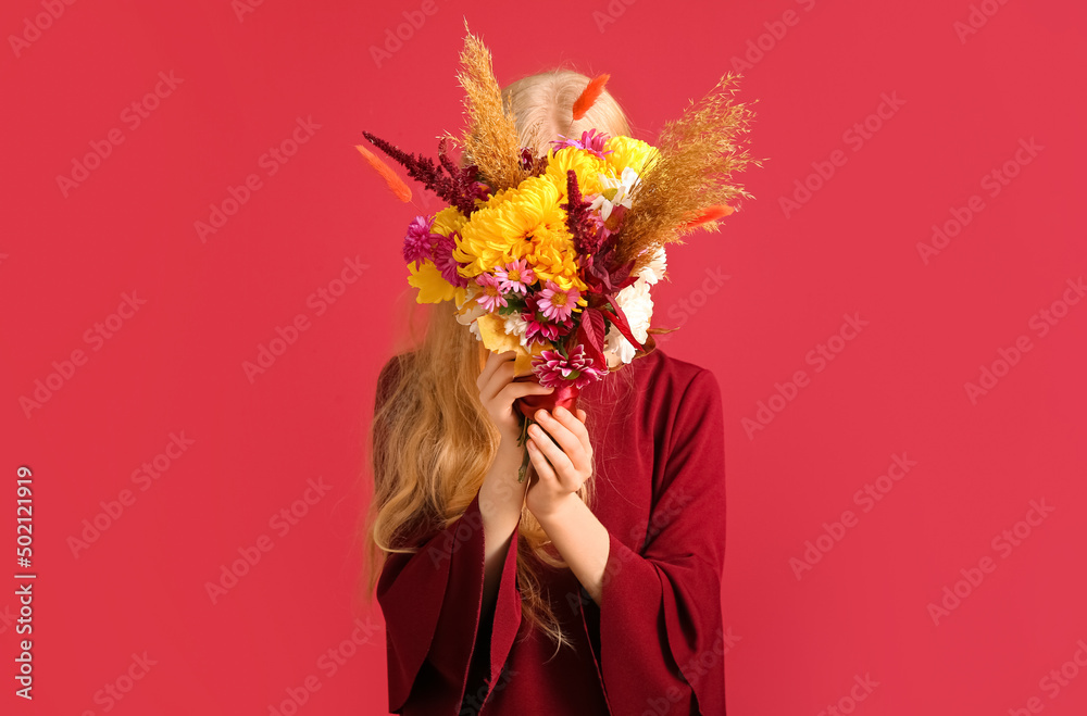 Woman with beautiful autumn bouquet on red background, closeup