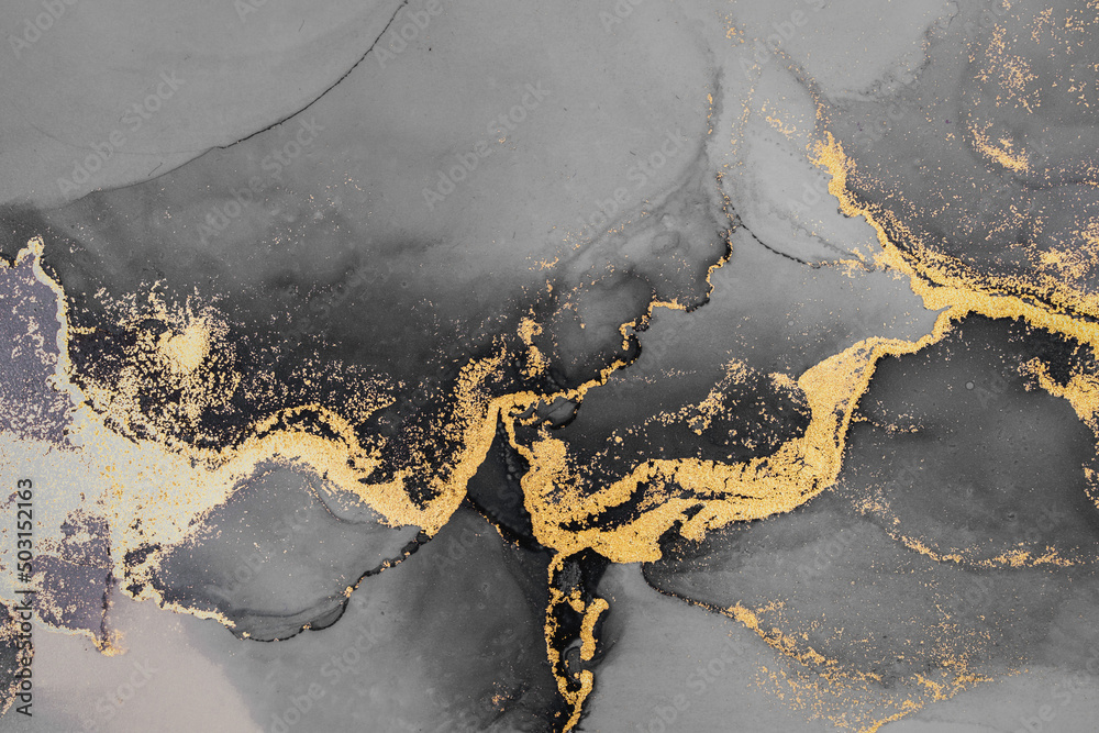 纸上大理石液体墨水艺术绘画的暗金色抽象背景。原始艺术品的图像