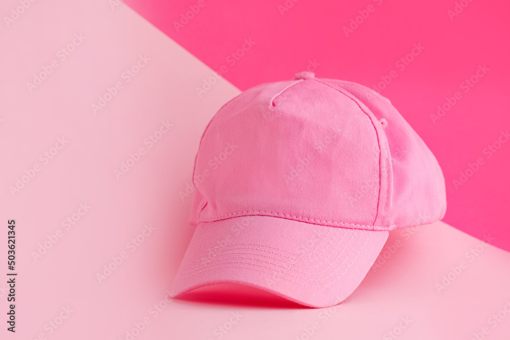 Stylish cap on color background