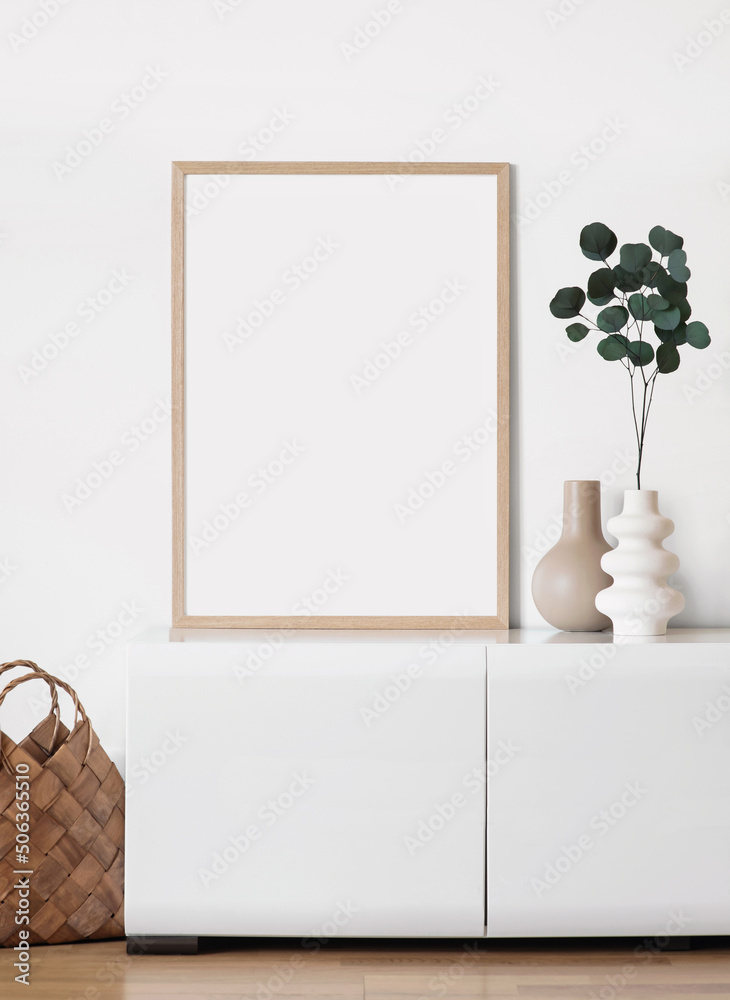Blank picture frame mockup on gray wall. White living room design. View of modern scandinavian style