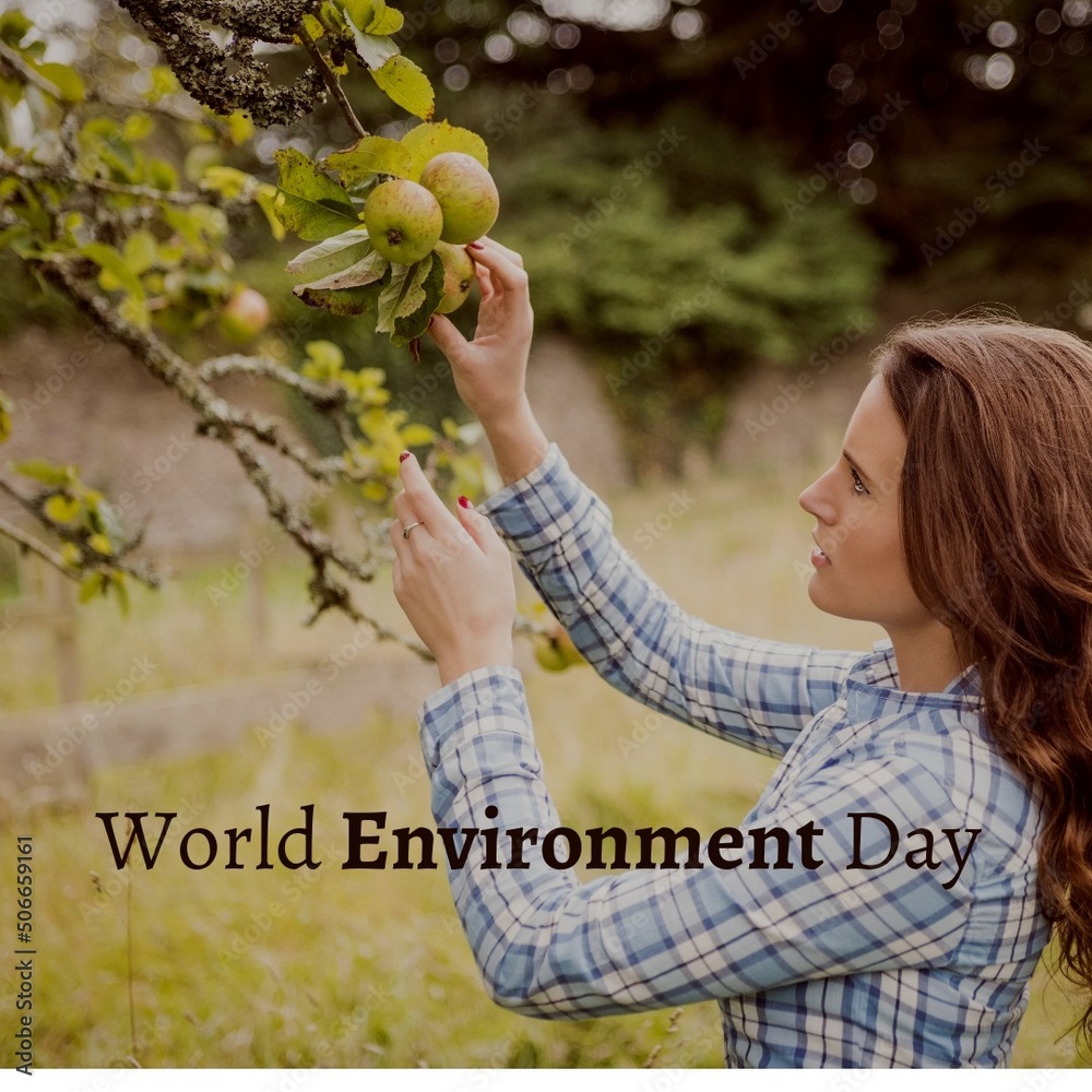 Digital composite image of caucasian young woman picking apple with world environment day text