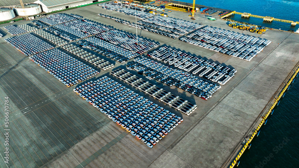 Aerial view a lot of new car for import and export shipping by ship; Smart dealership at car depot; 