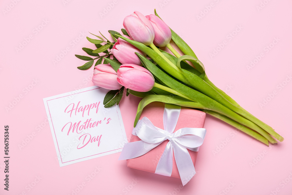 Card with text HAPPY MOTHERS DAY, tulips and gift box on pink background