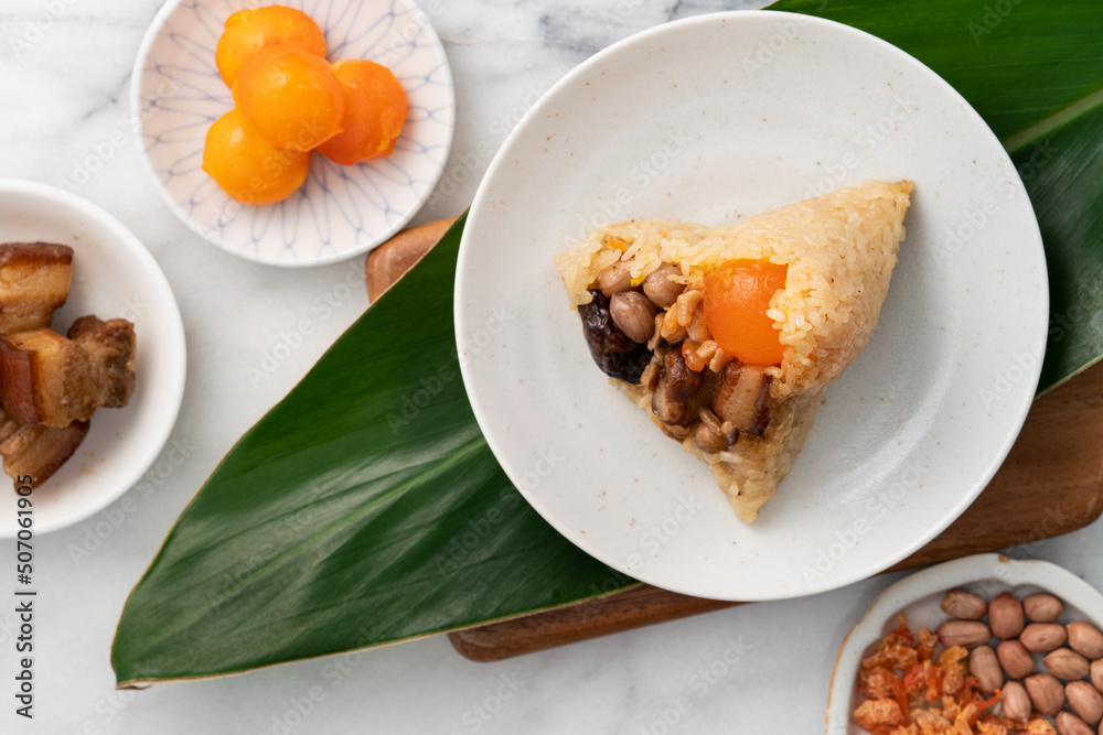 Zongzi. Rice dumpling for Dragon Boat Festival on bright marble table background with ingredient.