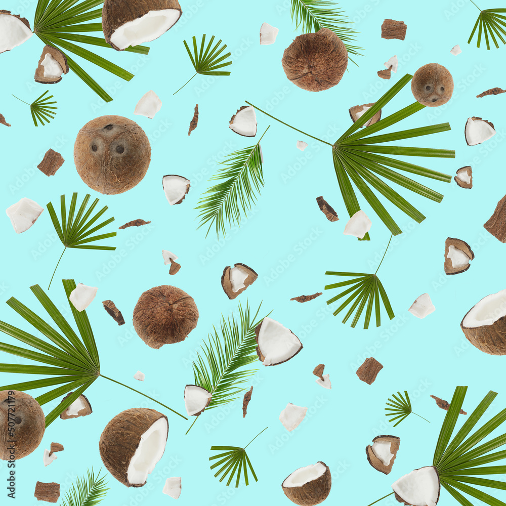 Many coconuts and tropical leaves on turquoise background. Texture for design