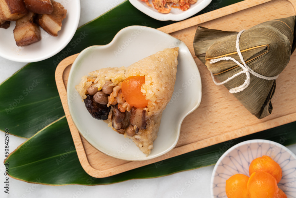 Zongzi. Rice dumpling for Dragon Boat Festival on bright marble table background with ingredient.