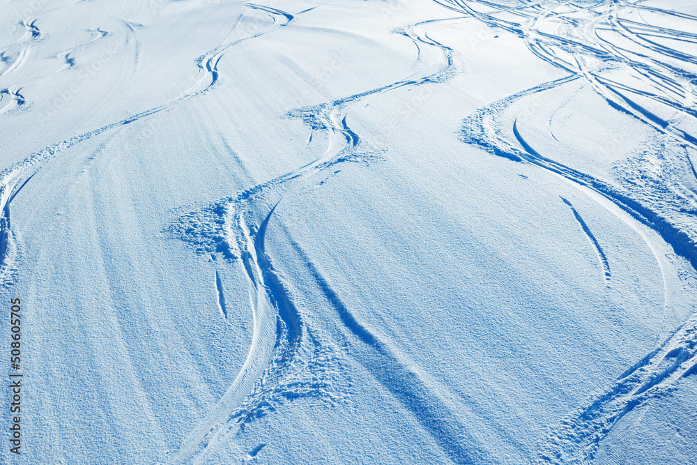 从上方看雪景中的滑雪板和单板滑雪板痕迹