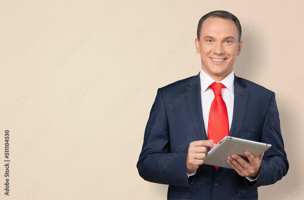 Happy successful business man holds use digital tablet