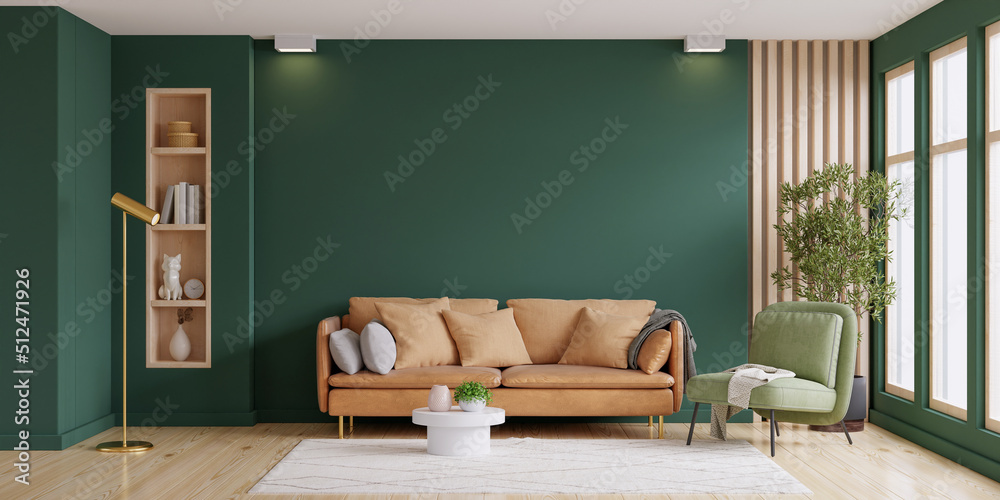 明亮的房间，空的深绿色墙壁背景上有沙发和扶手椅。