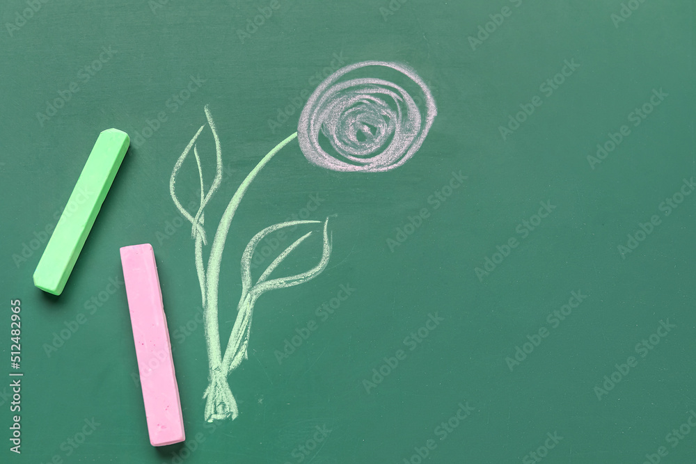 Drawn flower with chalks on blackboard