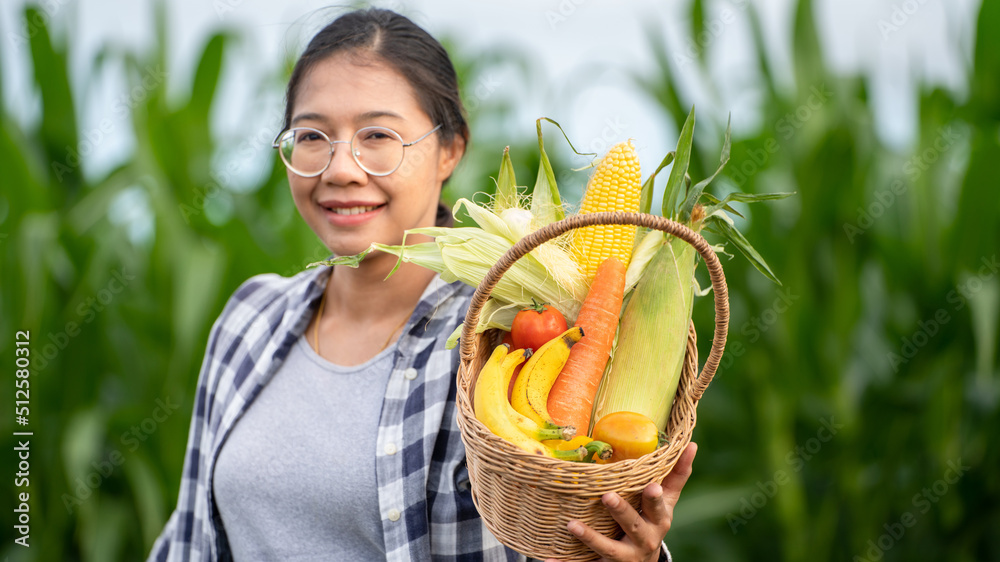 Beautiful young brunette Portrait Famer Woman hand holding Vegetables in the bamboo basket on green 