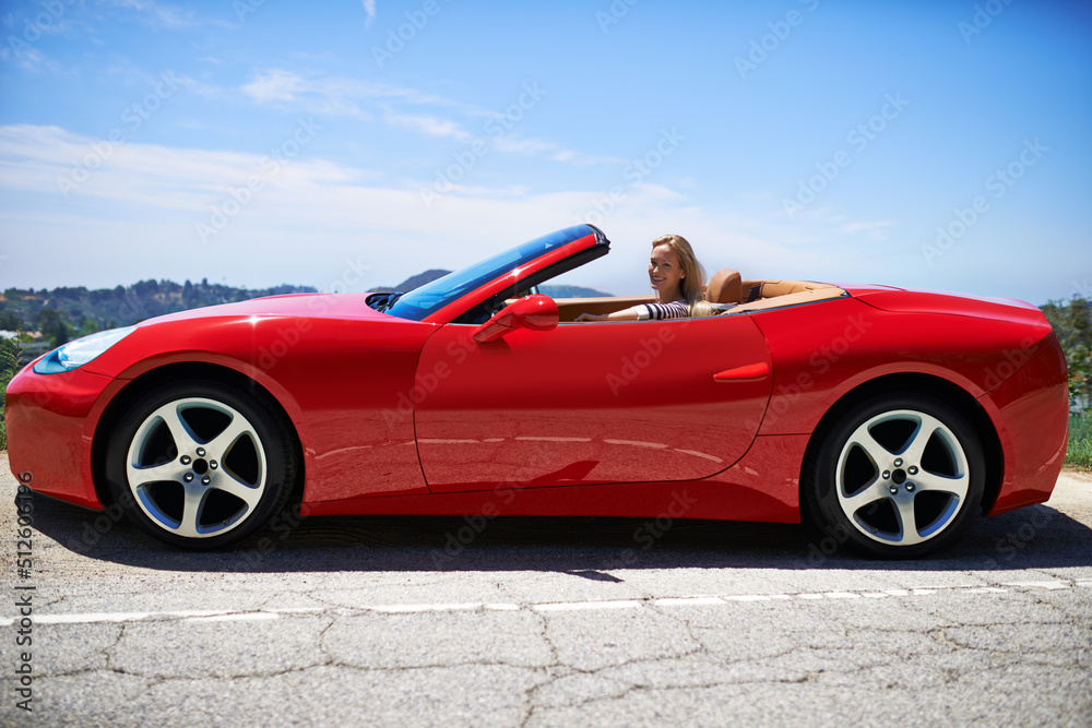 Yep, shes fast. Shot of a young woman driving in a sports car.