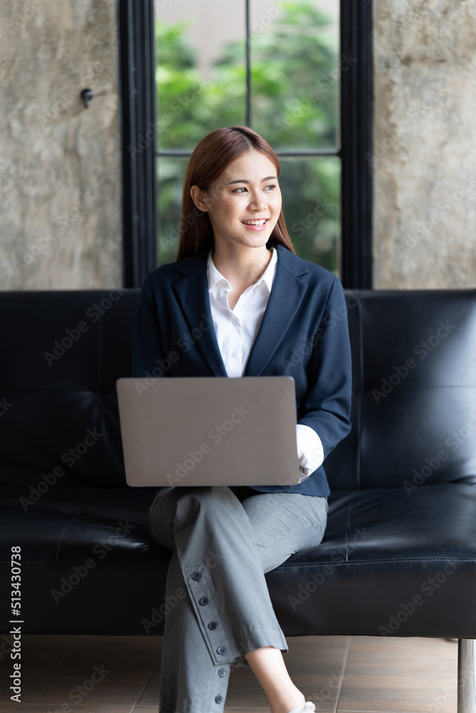 Asian woman typing email on laptop computer while sitting at home,Young Business Woman Working Creat