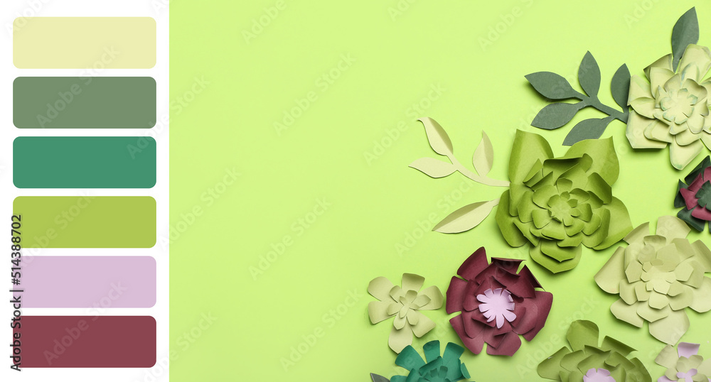 绿色背景下美丽的手工纸花。不同的颜色图案