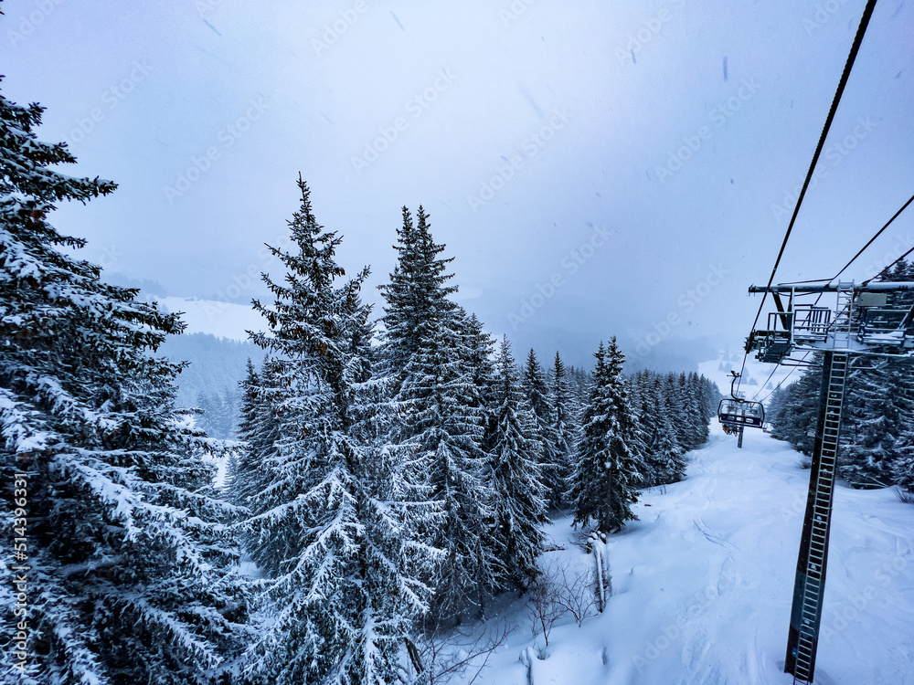 View from ski lift on snow covered firs forest after snowstorm