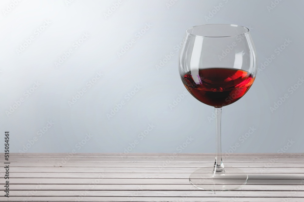 Red wine in a glass on light background
