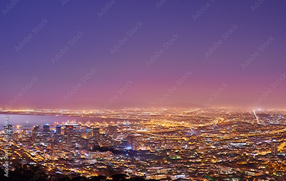 Cape Town after sunset, a cityscape view from Signal Hill, South Africa. Bright lights over a city l