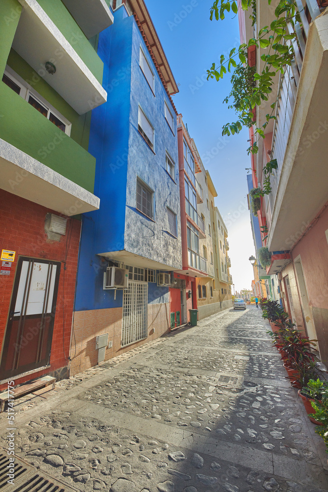 Historical city street view of residential houses in small and narrow alley or road in tropical Sant