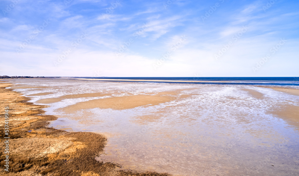 Landscape of beach sand with ocean and blue cloudy sky background on the Eastcoast shoreline line Ka