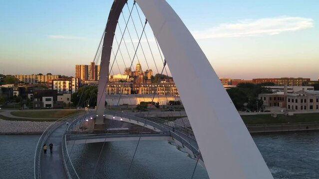 Colorful sunset aerial drone view of Center Street Bridge with gold-domed Iowa capitol building in far distance