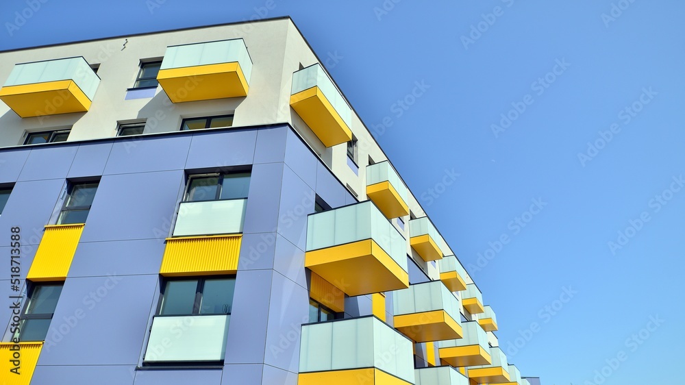 Exterior of new apartment buildings on a blue cloudy sky background. No people. Real estate business