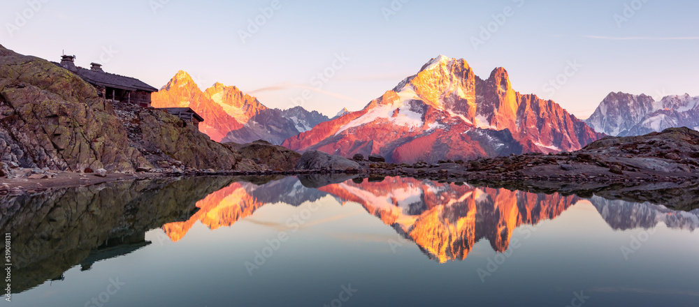Colourful sunset on Lac Blanc lake in France Alps. Monte Bianco mountain range on background. Vallon