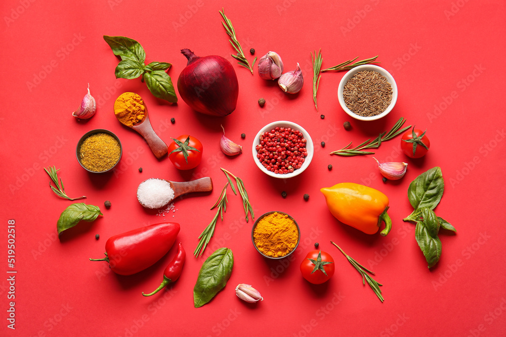 Beautiful composition with different spices, vegetables and herbs on color background