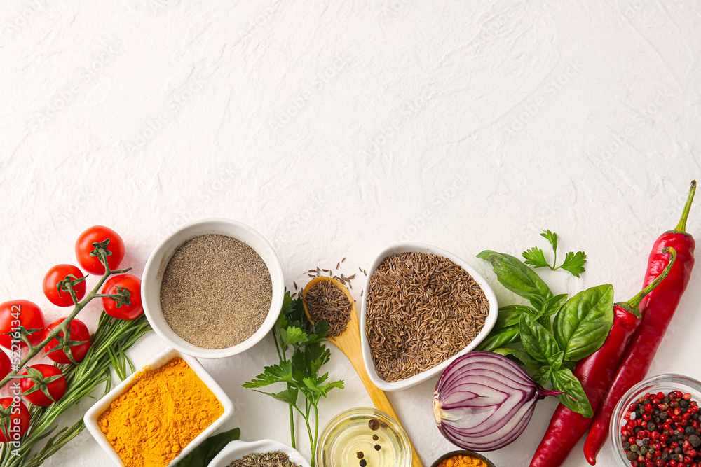 Composition with aromatic spices, herbs and vegetables on light background