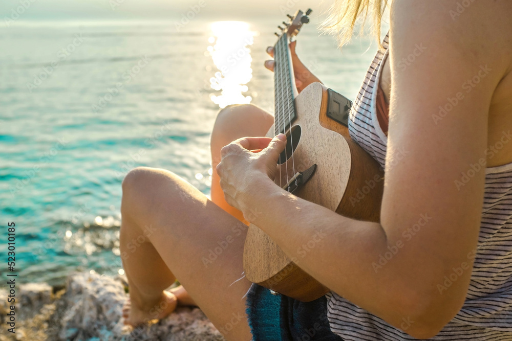 women relaxing and playing on ukulele on beach, so happy and luxury in holiday summer, outdoors suns