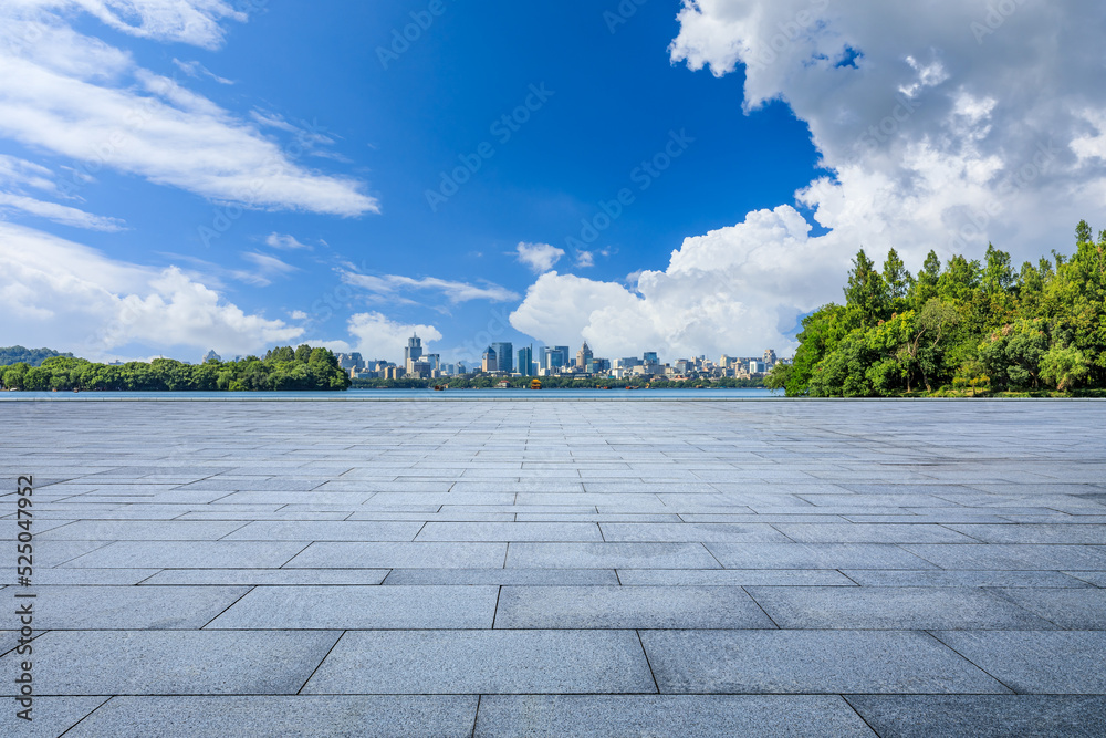 Empty city square and green tree with modern city skyline in Hangzhou, China.
