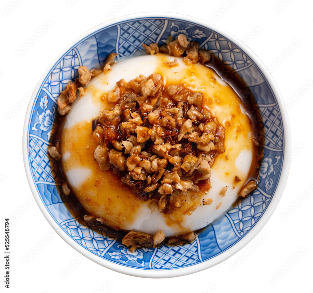 Taiwanese savory rice pudding Wa gui with chopped dried radish and soy sauce isolated on white backg