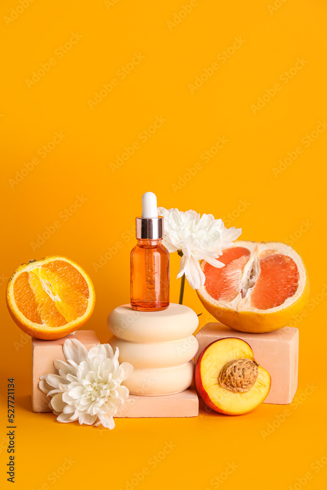 Composition with bottle of essential oil, fruits, flowers and plaster stands on color background