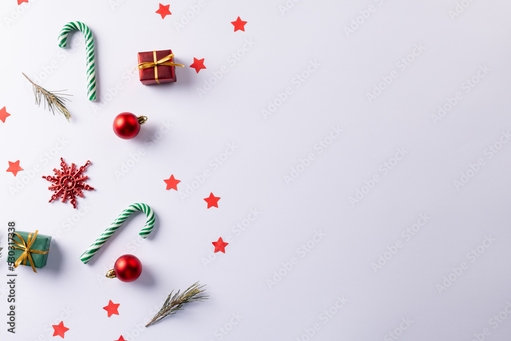 白色背景下的圣诞手杖、礼物、圣诞树枝和装饰品