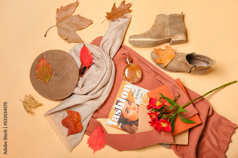 Female accessories, fashion magazine, flowers and autumn leaves on beige background