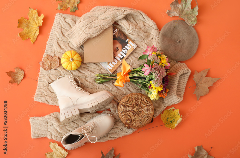 针织毛衣，时尚的女性配饰，橙色背景上的花束和秋叶