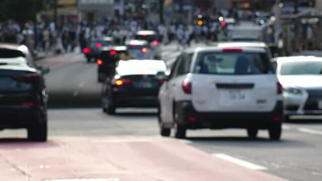 SHIBUYA, TOKYO, JAPAN : Out of focus view of street traffic around Shibuya crossing in busy rush hour. Shot in sunset time. Many cars and taxi at the road. Japanese transportation concept video.