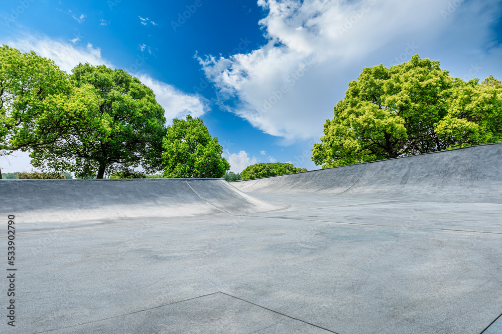 Empty cement square and green tree with sky cloud background