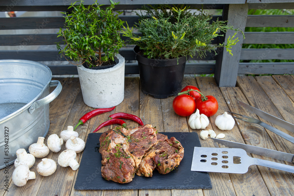 Marinated beef steak on wooden table top. Healthy food concept. Beef cut and spices for cooking bbq 