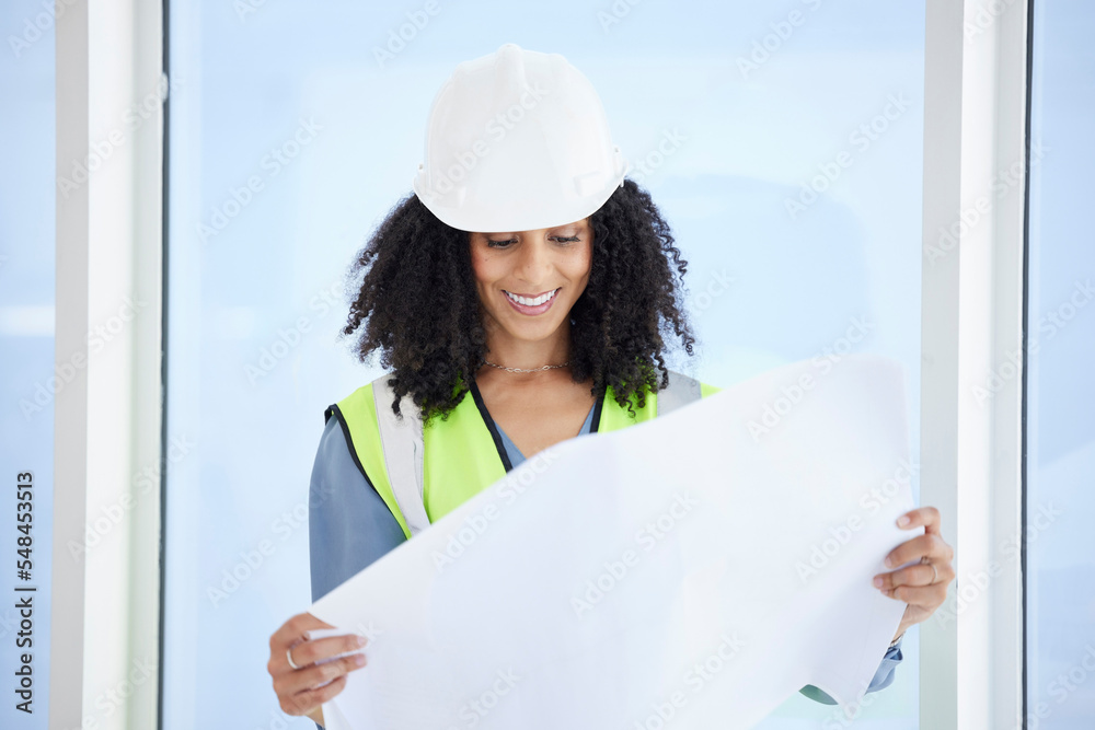 建筑师、工程师或女性，手里拿着蓝图、规划或施工文件的纸。