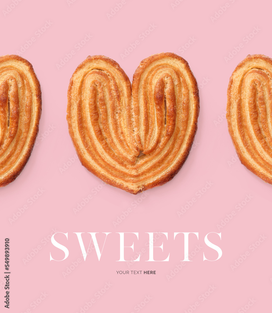 由法国棕榈饼干在粉色背景上制成的创意布局。平躺。食物概念。甜