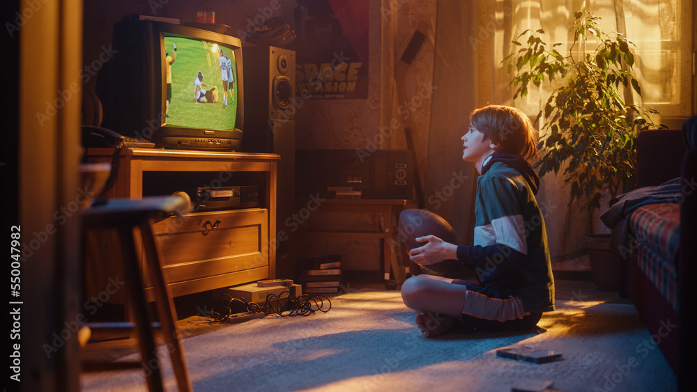 Young Sports Fan Watches American Football Match on Retro TV in His Vintage Room with Dated Interior