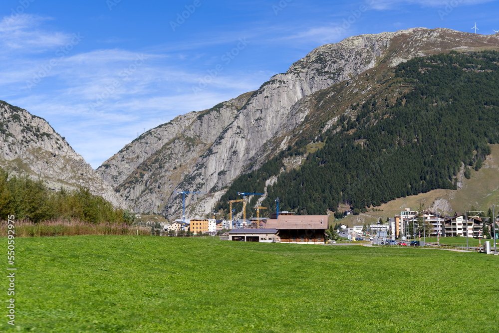 Scenic view of mountain panorama in the Swiss Alps with mountain village Andermatt on a sunny late s